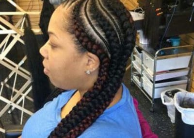 a woman having a unique hair braiding style